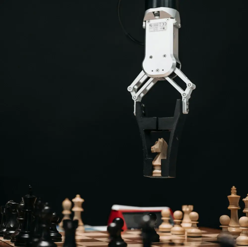 Arm moving a chess piece.