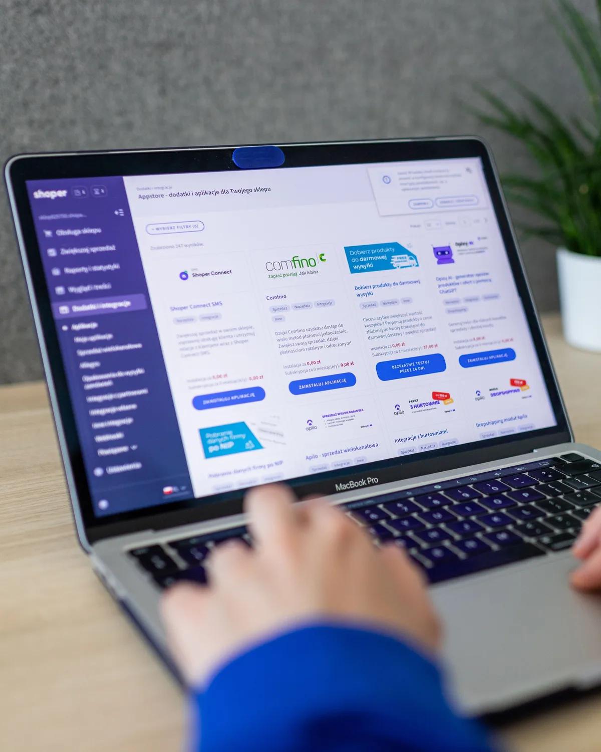 Hands on a laptop keyboard with a business website open on the screen.